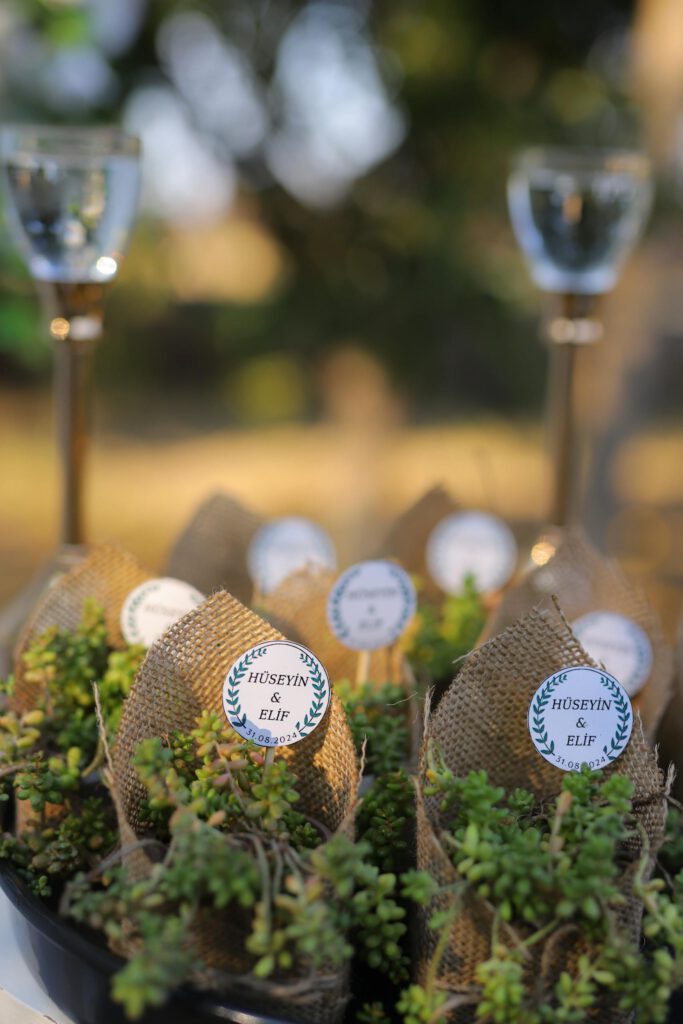 Beautiful rustic wedding favors with burlap wrap and greenery, perfect for an outdoor celebration.